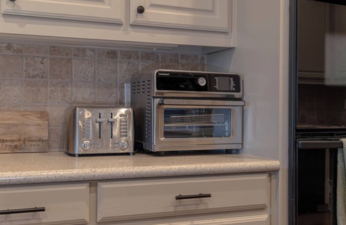 Westminster House | Modern country comfort in this 4-bedroom Anna retreat near McKinney. Sleeps 12 with open layout, full kitchen, foosball, and covered patio with BBQ. Rustic Texas charm with modern amenities — perfect for family or group getaways.