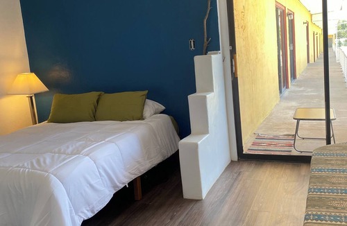 Tucumcari Hotel | Southwest adobe style bancos & faux kiva fireplace with RT 66 views. Walk to all