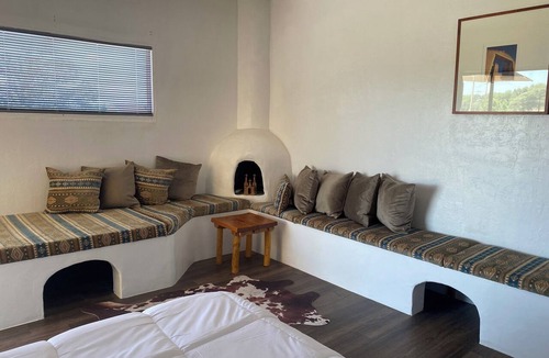 Tucumcari Hotel | The Banco Room, a handcrafted Southwest retreat with Adobe bancos & Kiva frplc