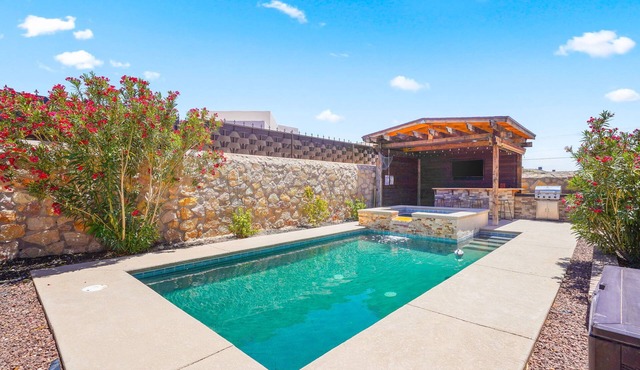 This is a true retreat in El Paso with a sparkling pool (w heater), hot tub, and full outdoor entertaining area with a smart TV, tiki bar, and grill.