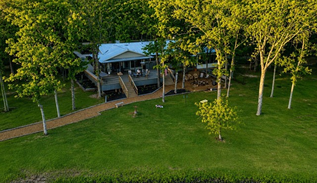 WHISPERING PINES — PRIVATE LAKEFRONT RETREAT ON 240 ACRES